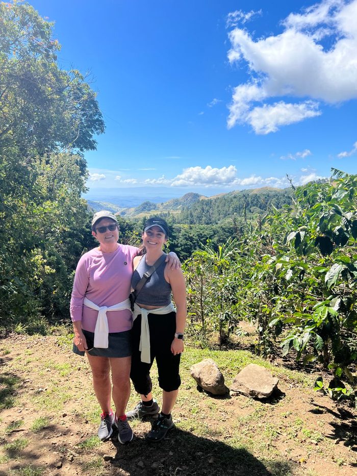 Ari and her mom smiling together on a mountain hike